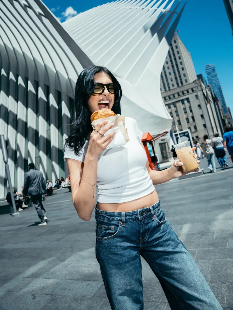 A woman with a pastry outside the Oculus